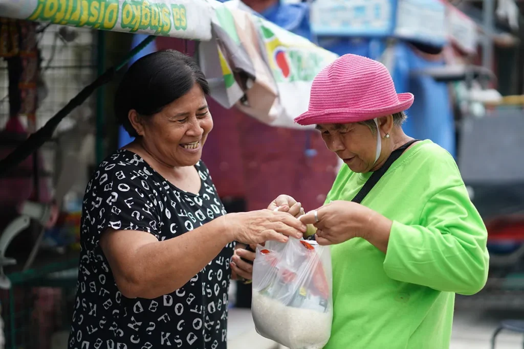A Plastic Bank member in the Philippines buys groceries with the income earned from collecting plastic.